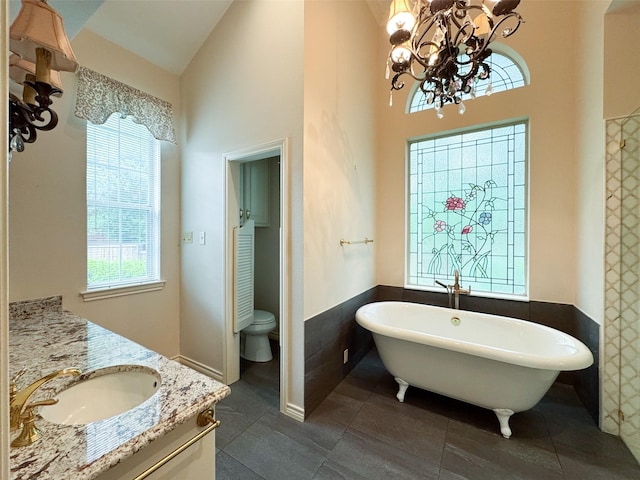 1520 Gatewood Dr, Denton, TX 76205 - full bath with a chandelier, a freestanding tub, toilet, tile patterned floors, and vanity