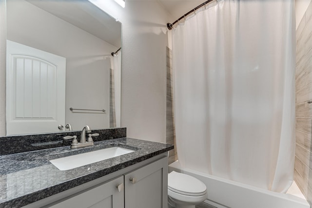 bathroom featuring toilet, shower / tub combo, and vanity