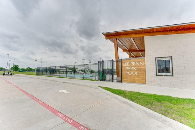 surrounding community with fence and a tennis court