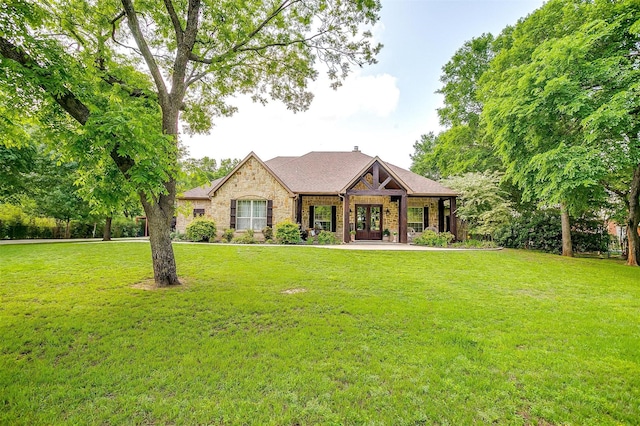 1320 Fox Ln, Burleson, TX 76028 - view of front facade with a front lawn, french doors, and stone siding