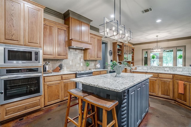 1320 Fox Ln, Burleson, TX 76028 - kitchen featuring a center island, concrete floors, appliances with stainless steel finishes, and backsplash