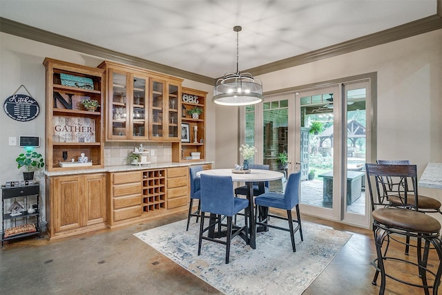 1320 Fox Ln, Burleson, TX 76028 - kitchen with finished concrete floors, ornamental molding, stainless steel microwave, and backsplash