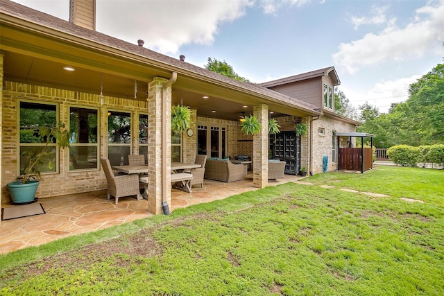 1320 Fox Ln, Burleson, TX 76028 - back of house featuring roof with shingles, brick siding, an outdoor living space, a patio area, and a yard