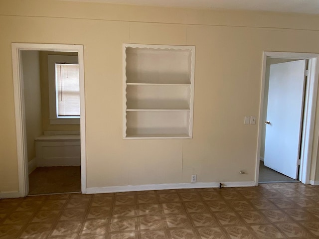 empty room featuring baseboards