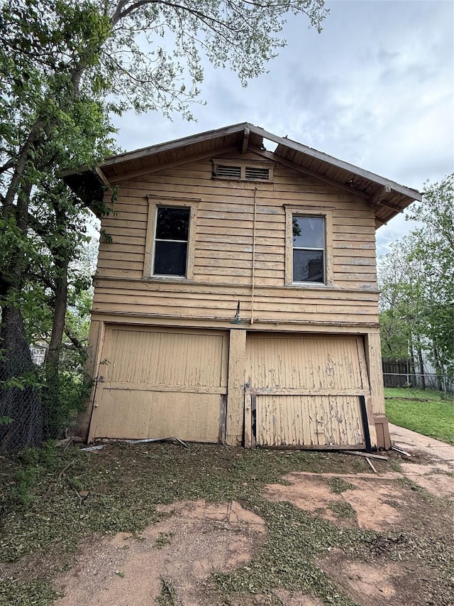 view of side of home with fence