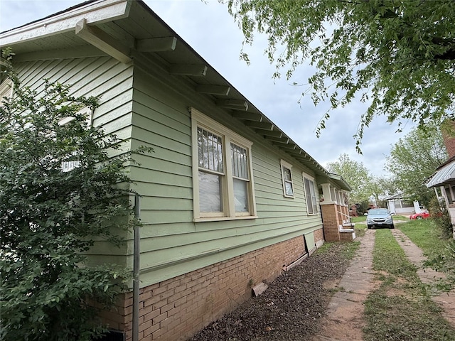 view of side of property featuring brick siding