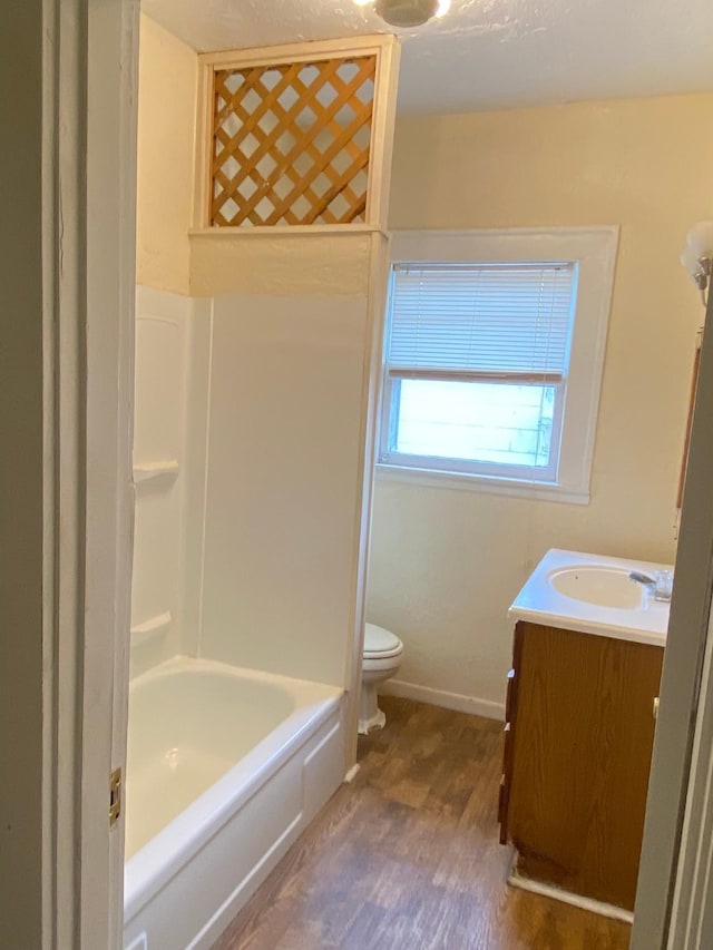 bathroom with vanity, baseboards, toilet, and wood finished floors