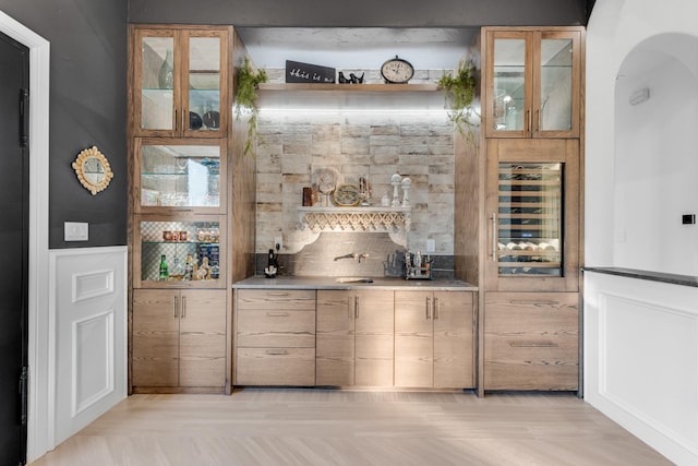 7242 Waters Edge Dr, The Colony, TX 75056 - bar featuring wine cooler, arched walkways, tasteful backsplash, and indoor wet bar