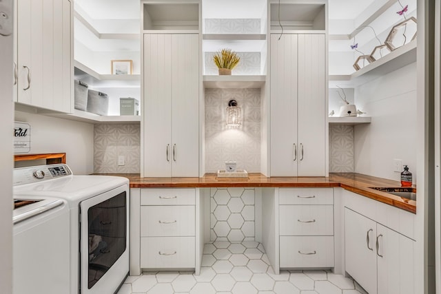 7242 Waters Edge Dr, The Colony, TX 75056 - laundry area featuring washer and dryer, a sink, light tile patterned floors, and cabinet space
