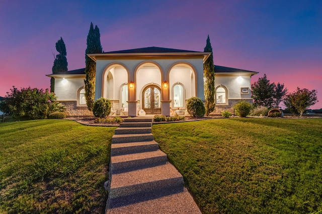 7242 Waters Edge Dr, The Colony, TX 75056 - mediterranean / spanish-style home with french doors, stucco siding, and a yard