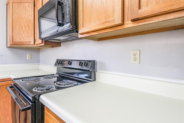 kitchen with light countertops and black appliances