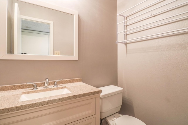 half bathroom with toilet and vanity