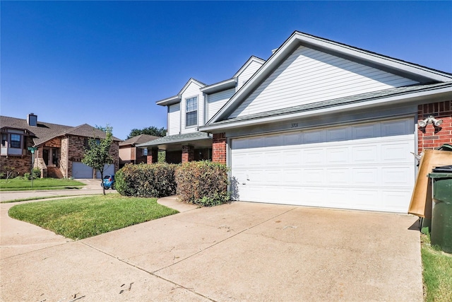 traditional home featuring concrete driveway, brick siding, and an attached garage