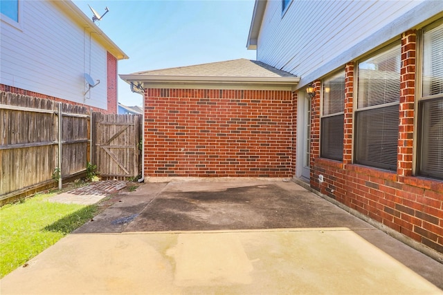 view of patio with fence and a gate