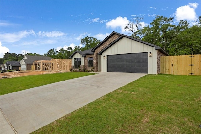 modern farmhouse style home with a garage, a gate, board and batten siding, and a front yard