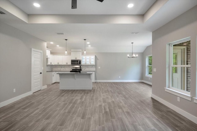 kitchen featuring appliances with stainless steel finishes, a wealth of natural light, baseboards, and open floor plan