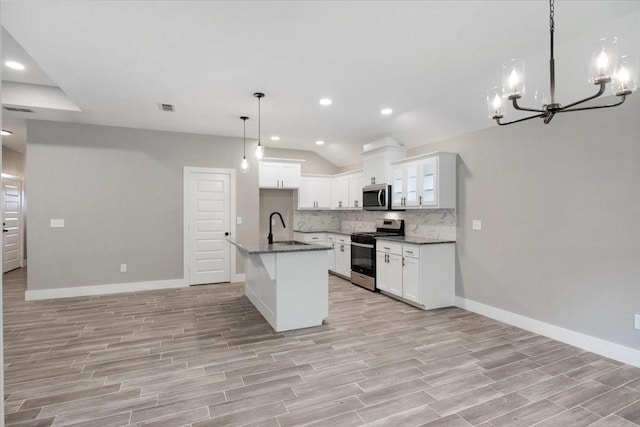 kitchen with recessed lighting, a chandelier, tasteful backsplash, light wood finished floors, and appliances with stainless steel finishes