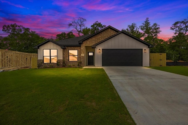 view of front of house featuring fence, brick siding, a garage, a front yard, and concrete driveway