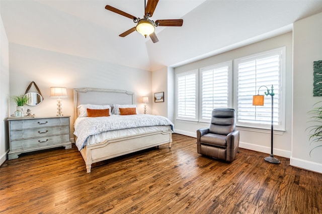 bedroom with baseboards, a ceiling fan, wood finished floors, and vaulted ceiling