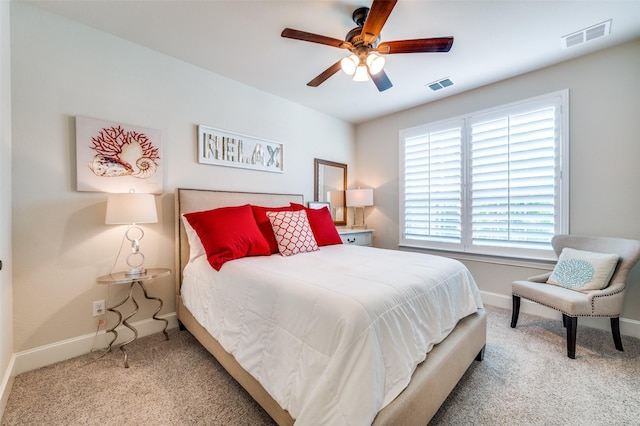 carpeted bedroom with baseboards, ceiling fan, and visible vents