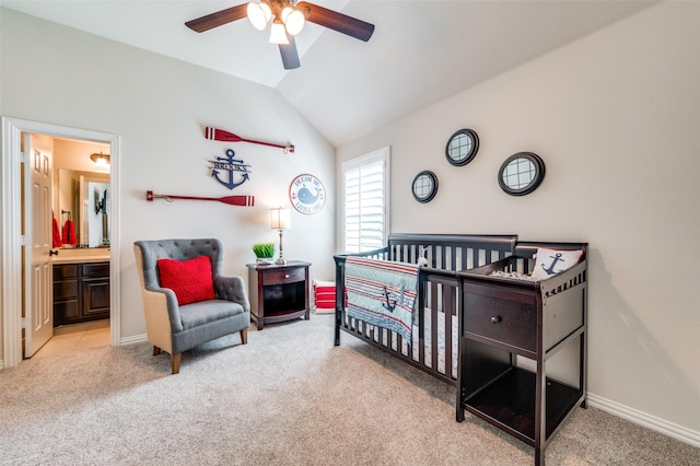 bedroom with vaulted ceiling, baseboards, ensuite bathroom, and carpet flooring