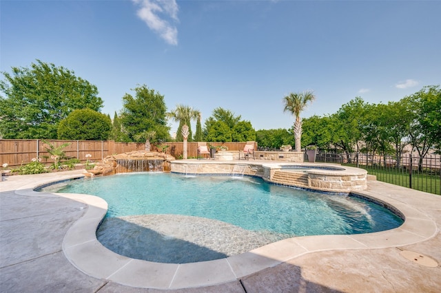 view of pool featuring a fenced backyard, a pool with connected hot tub, and a patio area