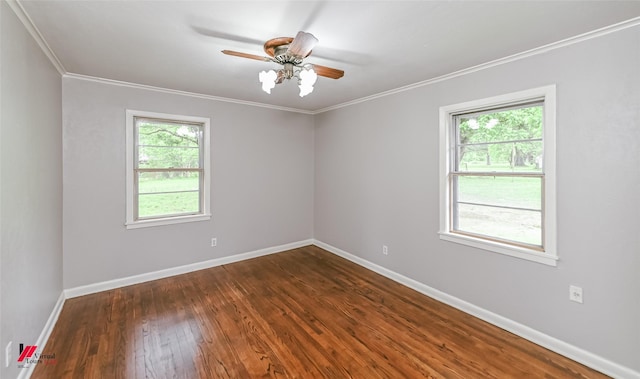 spare room with crown molding, baseboards, dark wood-type flooring, and ceiling fan