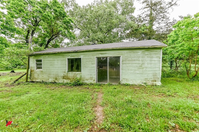 rear view of house with a yard