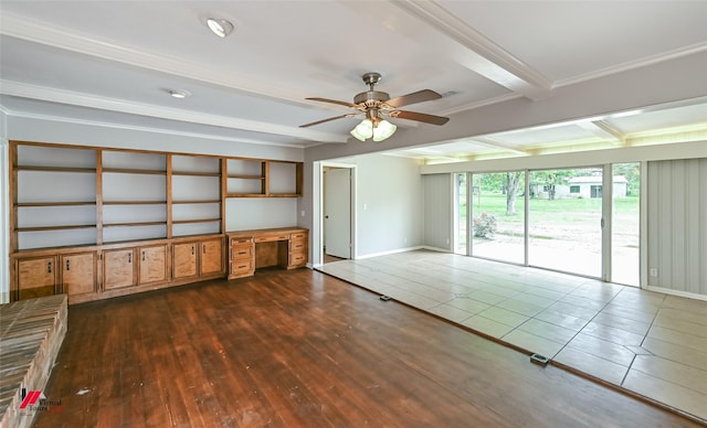 spare room featuring ornamental molding, a ceiling fan, baseboards, beamed ceiling, and dark wood-style floors