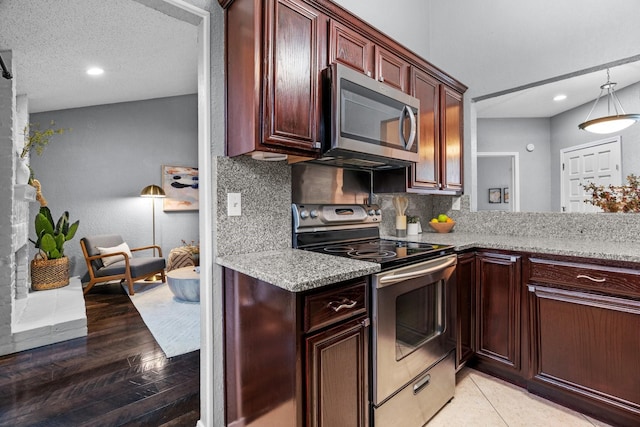 kitchen with appliances with stainless steel finishes, decorative backsplash, recessed lighting, and light stone counters