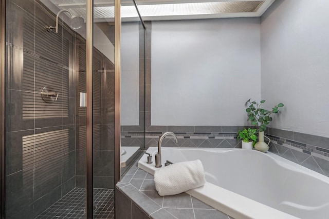 full bath featuring a bath and a shower stall