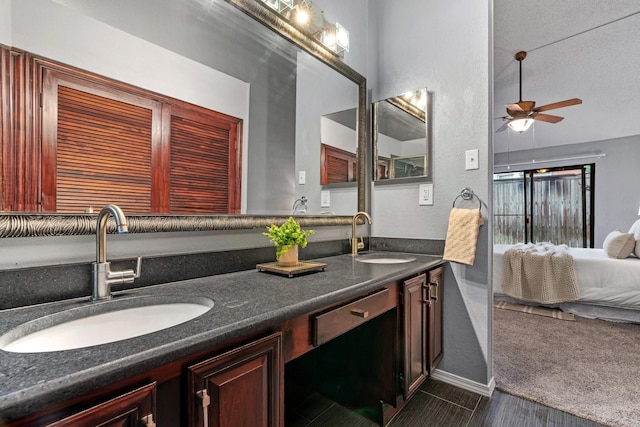 full bath with double vanity, a sink, ceiling fan, and ensuite bathroom