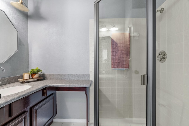 bathroom with vanity and a shower stall