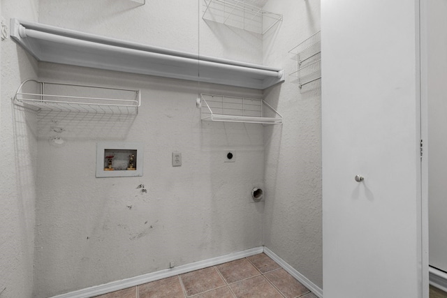 laundry room with hookup for an electric dryer, laundry area, baseboards, tile patterned floors, and hookup for a washing machine