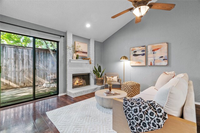 living area featuring a brick fireplace, wood finished floors, ceiling fan, recessed lighting, and vaulted ceiling