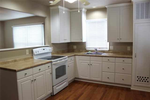 kitchen featuring a ceiling fan, electric range, white cabinetry, a sink, and dark wood finished floors