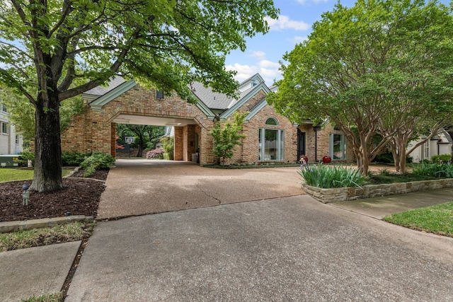 view of front facade with concrete driveway and brick siding