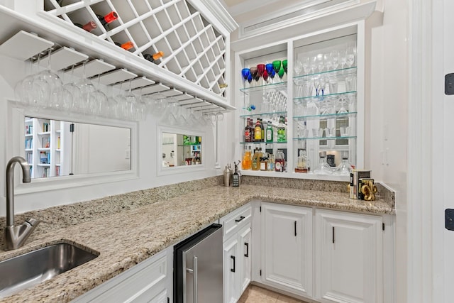 bar with high end fridge, bar area, and a sink