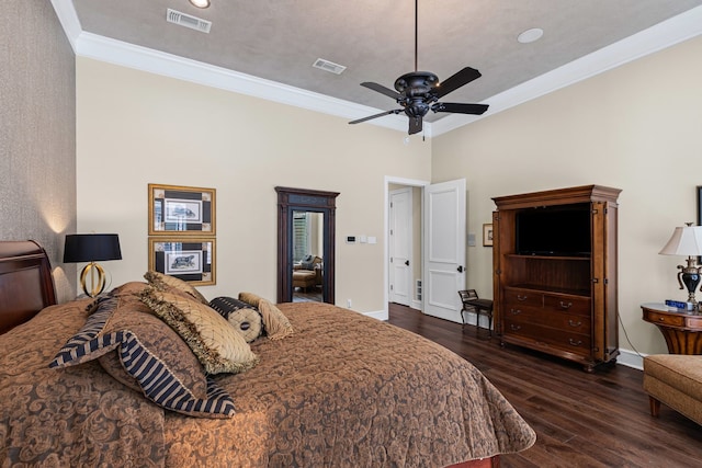 bedroom with baseboards, visible vents, ornamental molding, and hardwood / wood-style floors