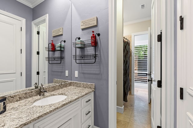 full bathroom with visible vents, tile patterned flooring, vanity, baseboards, and ornamental molding