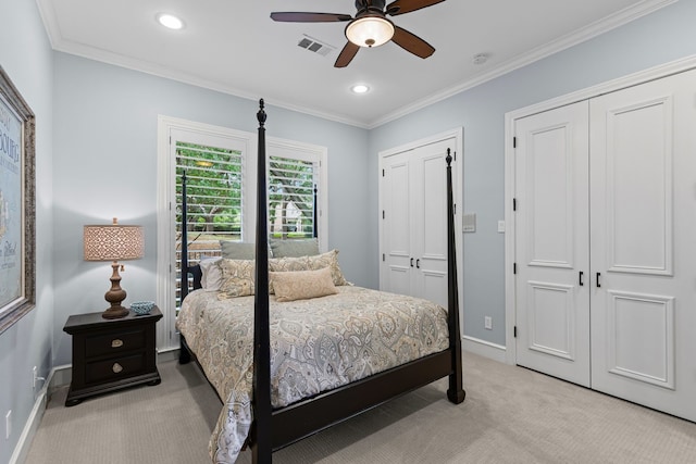 bedroom featuring multiple closets, visible vents, baseboards, and light colored carpet