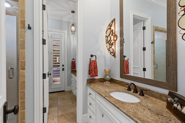 full bathroom with vanity, ornamental molding, a shower stall, and tile patterned flooring