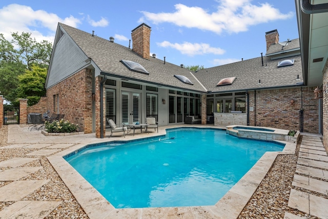 view of swimming pool featuring central AC unit, outdoor lounge area, a patio area, and a pool with connected hot tub