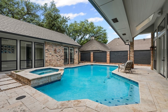 view of pool with a patio area, a pool with connected hot tub, and fence