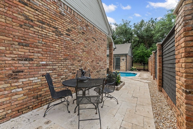 view of patio featuring a fenced in pool, fence, and outdoor dining space