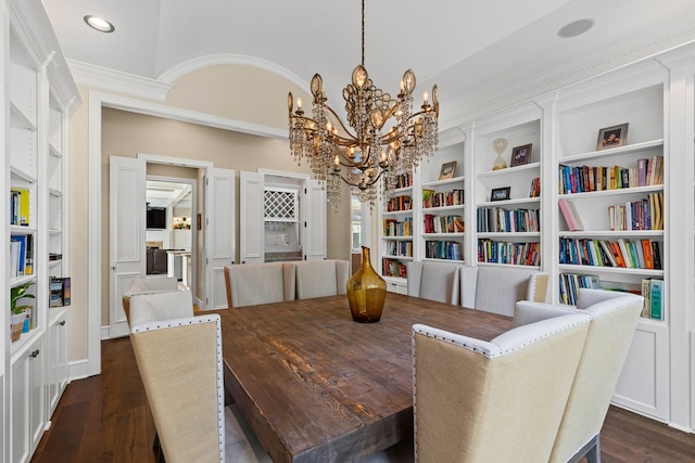 dining space with an inviting chandelier, crown molding, built in features, recessed lighting, and dark wood finished floors
