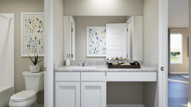 full bath with vanity, baseboards, wood finished floors, and toilet