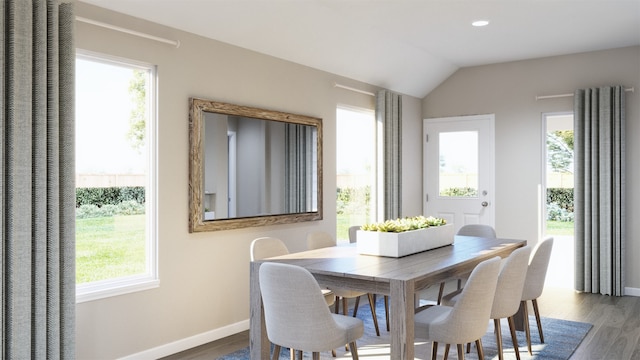 dining area with plenty of natural light, baseboards, lofted ceiling, and wood finished floors