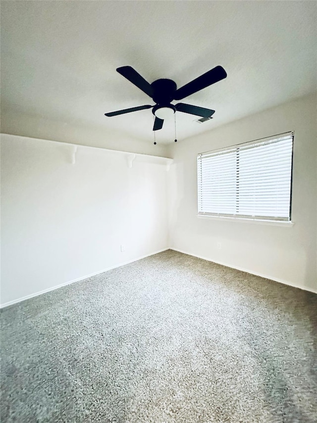 unfurnished room with ceiling fan and baseboards