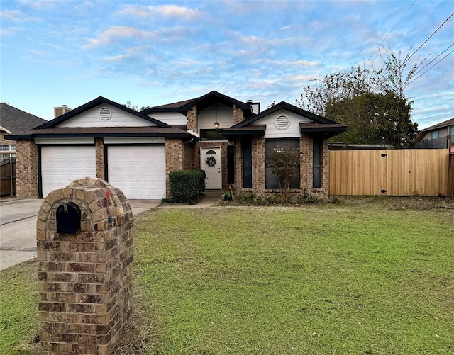 view of front facade with fence, a front lawn, brick siding, a garage, and concrete driveway